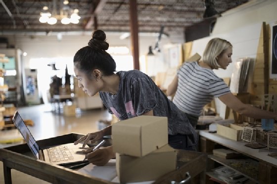E-commerce shop picking and packing merchandise orders.