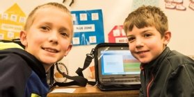 Two students with a district-issued Chromebook