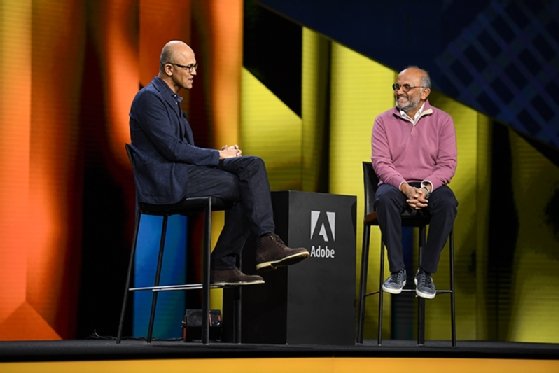 Photo of Adobe CEO Shantanu Narayen talking with Microsoft CEO Satya Nadella