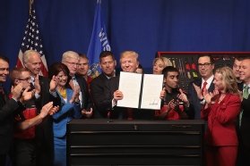 President Trump signs an executive order around his 'Buy American and Hire American' initiative.