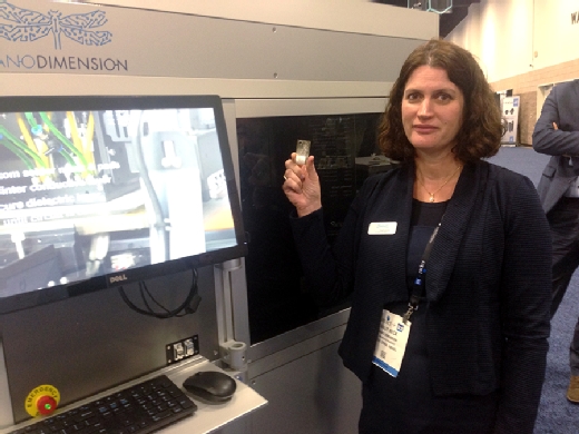 Galit Beck of Nano Dimension displays a wafer-thin PCB printed by the Nano Dimension DragonFly. 