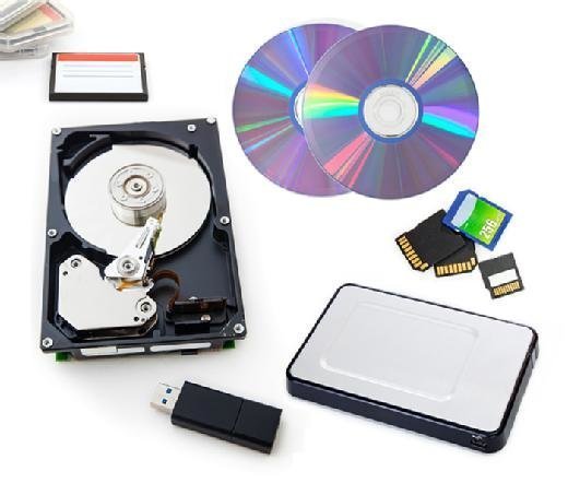 Photo of different types of storage media, including a hard drive and compact discs.
