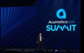 Acumatica CPO Ali Jani on stage at Acumatica Summit 2024.