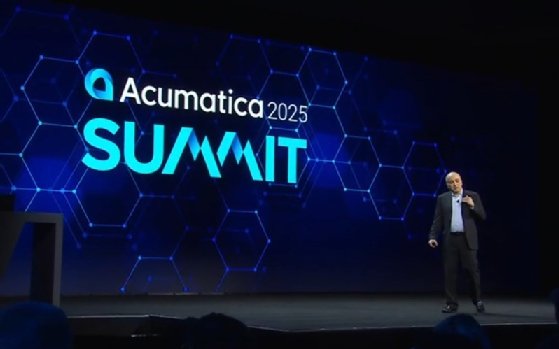This image shows Acumatica Chief Product Officer Ali Jani speaking on stage at the Acumatica Summit 2025.