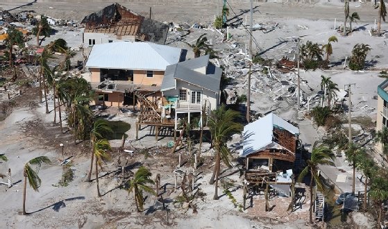 Buildings damaged by Hurricane Ian this week. Rebuilding may be slowed by low unemployment rates.