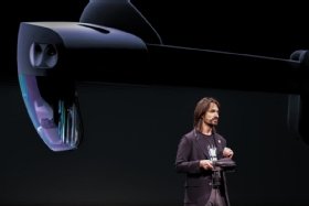 Alex Kipman standing in front of HoloLens 2 image
