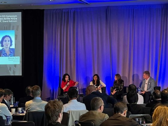 Photo of Melissa Swift, Reshmi Ramachandran, Monica Caldas and Tom Peck sitting on stage at MIT Sloan CIO Symposium. 