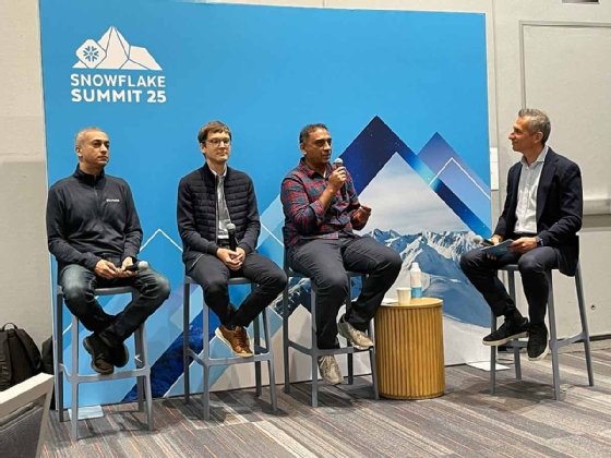 Meta's Amit Sangani, Stanford professor Jure Leskovec, and Snowflake's Dwarak Rajagopal and Baris Gultekin seated on stage during Snowflake Summit.